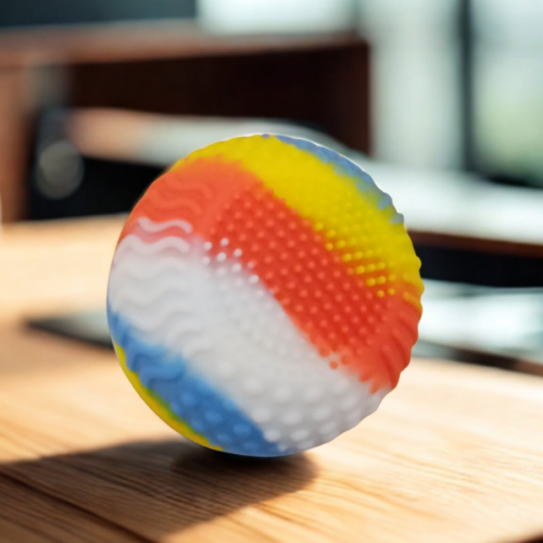 Close-up of a ZenSphere focus ball showing wavy and dotted textures for sensory relief.